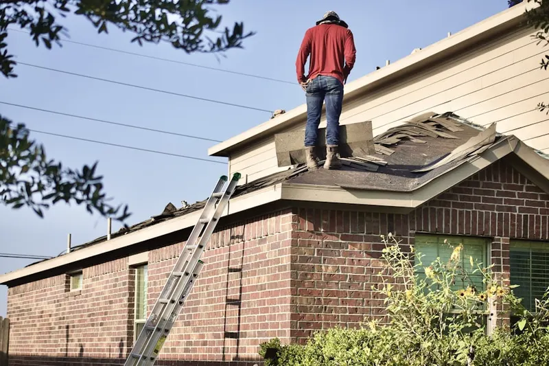 Professional roofer working on a residential roof in Oildale